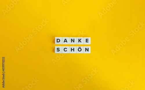 Danke Schön German Phrase on Letter Tiles on Yellow Orange Background. Minimal aesthetic.