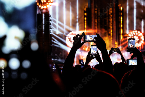 Taking photo or video content for social networks at the concert, Mobile phone on music show. photo