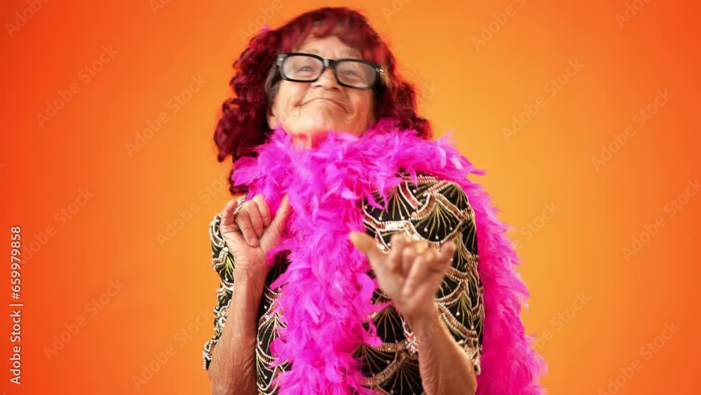 Portrait of shaka hand gesture given by funny crazy grandmother mature woman, 80s, acting isolated on orange background. Concept of elderly rock and roll. Portrait of shaka hand gesture given by funny crazy grandmother mature woman, 80s, acting isolated on orange background. Concept of elderly rock and roll.