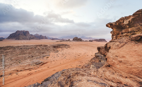 Red orange Mars like landscape in Jordan Wadi Rum desert, mountains background, overcast morning. This location was used as set for many science fiction movies photo