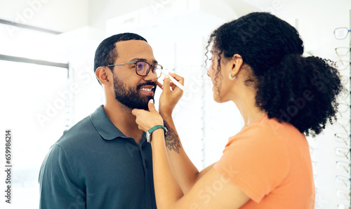 Man, woman optometrist and glasses fitting in store with prescription, eye care and healthy vision. Male customer, consulting and optician with spectacles for better eyesight, reading and wellness