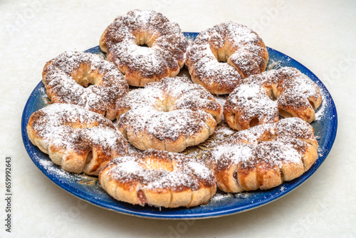 Apple rings baked in cinnamon dough and sprinkled with powdered sugar.