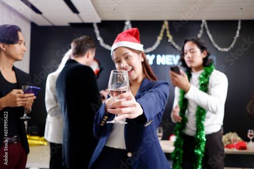 Young smiling happy teenagers celebrating Christmas, drinking champagne, Christmas party.