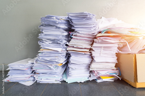 A stack of used papers or old documents was well packed and kept outside office, waiting for rubbish management