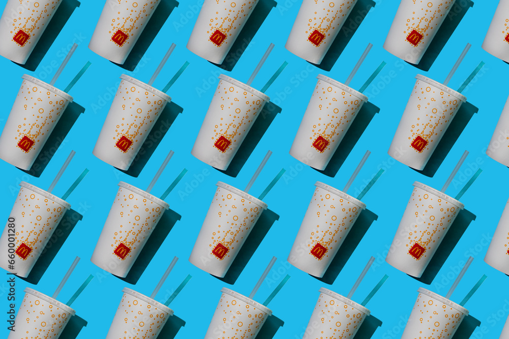 Yellow glass of McDonald's. Paper cup with lid. Takeaway drink ...