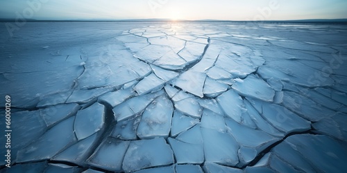 Dramatic, up-close shot of a crack forming in the ice of a frozen lake , concept of Fracture photo