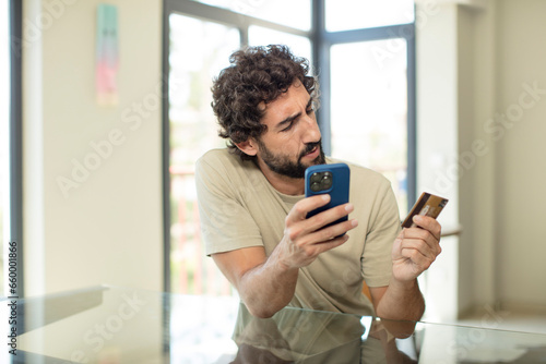 bearded hispanic man shopping with a credit card