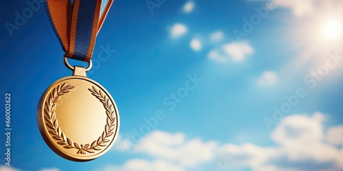 Gold medal hanging in the blue sky, winner against blue sky background copy space, sports, winning, achievement, game, sports business, success concept