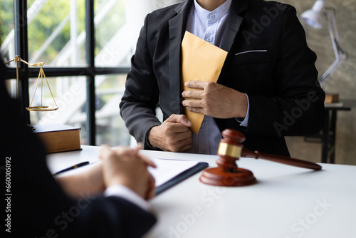 Attorney adjudicating bribery cases, Businessman trying to bribe a lawyer. photo