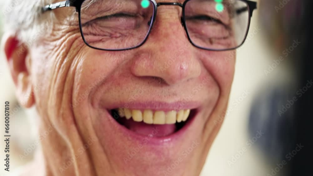 Close-up of a happy senior man laughing and smiling wearing glasses with friendly disposition Close-up of a happy senior man laughing and smiling wearing glasses with friendly disposition