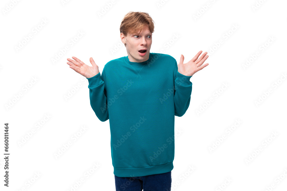 handsome redhead young man in blue sweater shows surprise handsome redhead young man in blue sweater shows surprise