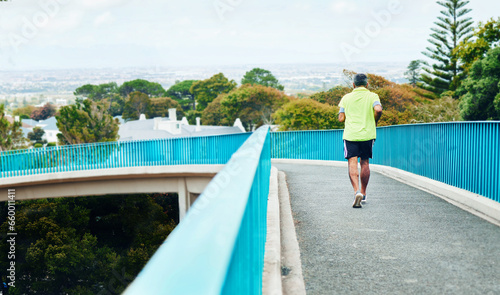 Back view, running or man on bridge on fitness journey or adventure for freedom, training or workout. Travel, holiday vacation or person on outdoor activity for cardio exercise or wellness in Peru