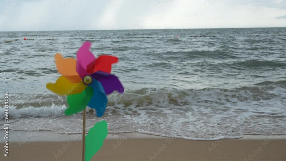 Wind spinners are spinning on the beach. Colorful plastic toy windmill spins in the wind against the sea. Symbol of freedom and life.
Wind spinners are spinning on the beach. Colorful plastic toy windmill spins in the wind against the sea. Symbol of freedom and life.