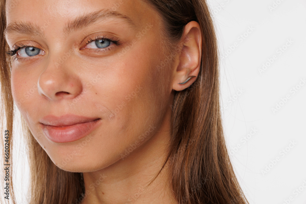 Beautiful young girl with fresh healthy skin. Woman advertise ear-rings. White background. Earrings, ear caffs closeup. Blond european woman with long hair with big lips, pretty smile. Cosmetology Beautiful young girl with fresh healthy skin. Woman advertise ear-rings. White background. Earrings, ear caffs closeup. Blond european woman with long hair with big lips, pretty smile. Cosmetology