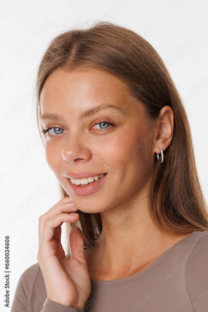 Beautiful young girl with fresh healthy skin. Woman advertise ear-rings. White background. Earrings, ear caffs closeup. Blond european woman with long hair with big lips, pretty smile. Cosmetology Beautiful young girl with fresh healthy skin. Woman advertise ear-rings. White background. Earrings, ear caffs closeup. Blond european woman with long hair with big lips, pretty smile. Cosmetology