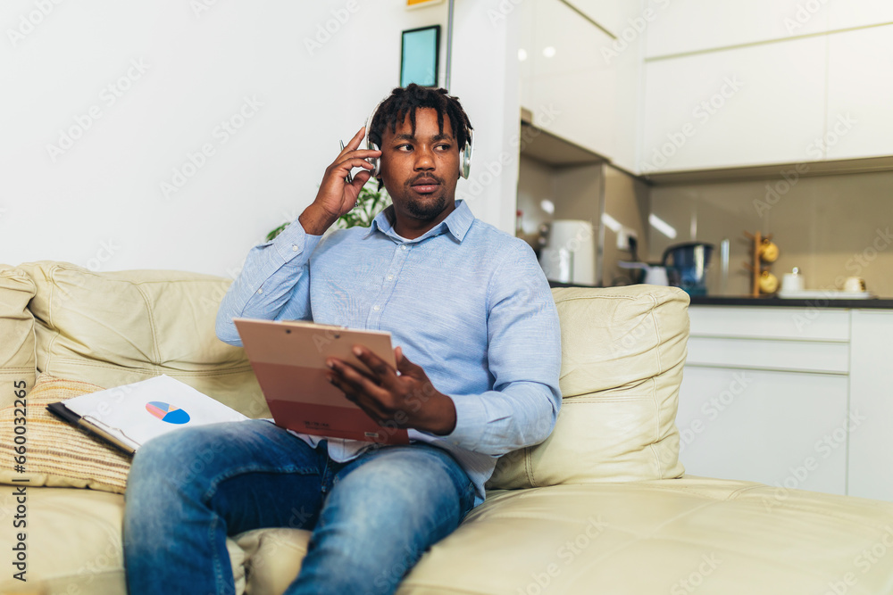 Handsome African American smiling freelancer working remotely from home