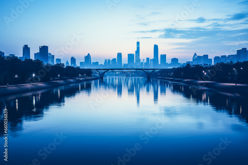 Landscape of bridge, river and city in cold blue morning light