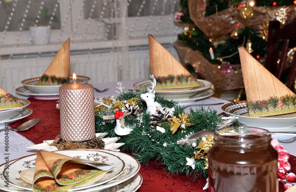 Lighting a Christmas candle on the Christmas table