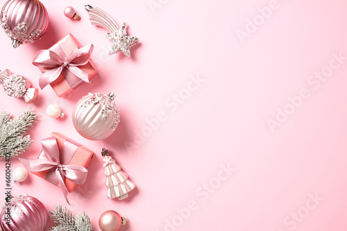 Christmas frame border of gift boxes, baubles, Christmas decorations on pastel pink background. Xmas greeting card, New Year banner design.