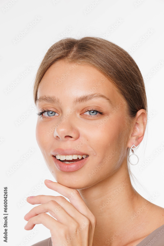 Beautiful young girl with fresh healthy skin. Woman advertise ear-rings. White background. Earrings, ear caffs closeup. Blond european woman with long hair with big lips, pretty smile. Cosmetology Beautiful young girl with fresh healthy skin. Woman advertise ear-rings. White background. Earrings, ear caffs closeup. Blond european woman with long hair with big lips, pretty smile. Cosmetology