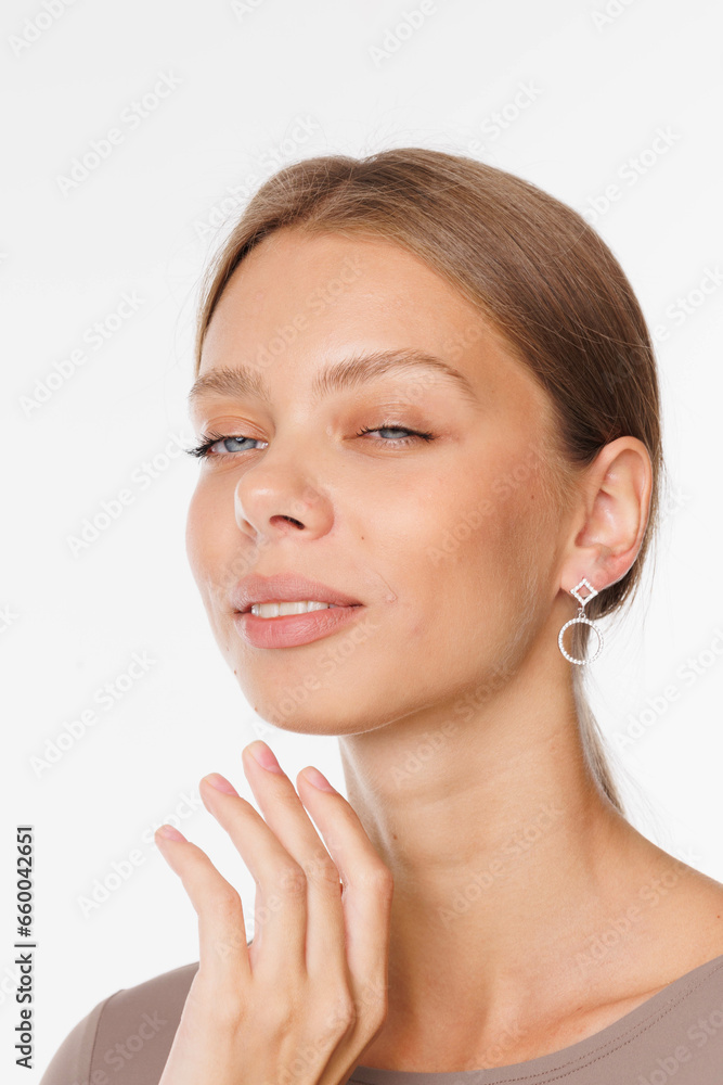 Beautiful young girl with fresh healthy skin. Woman advertise ear-rings. White background. Earrings, ear caffs closeup. Blond european woman with long hair with big lips, pretty smile. Cosmetology Beautiful young girl with fresh healthy skin. Woman advertise ear-rings. White background. Earrings, ear caffs closeup. Blond european woman with long hair with big lips, pretty smile. Cosmetology