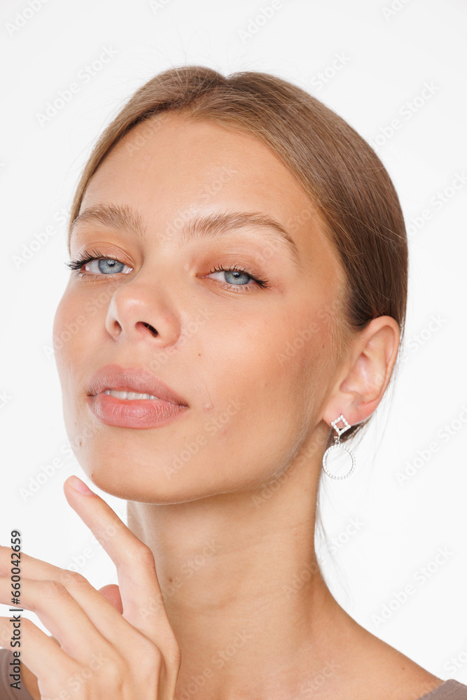 Beautiful young girl with fresh healthy skin. Woman advertise ear-rings. White background. Earrings, ear caffs closeup. Blond european woman with long hair with big lips, pretty smile. Cosmetology Beautiful young girl with fresh healthy skin. Woman advertise ear-rings. White background. Earrings, ear caffs closeup. Blond european woman with long hair with big lips, pretty smile. Cosmetology