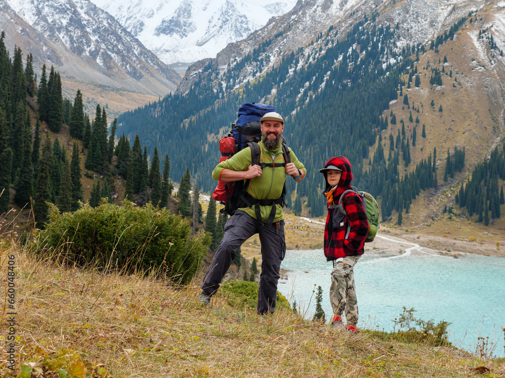 Father and son travel in the mountains. Live communication between dad and child. Family time outdoors