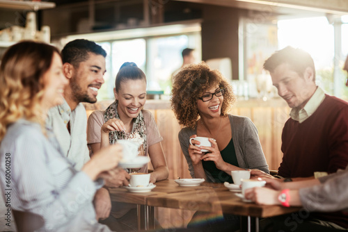 Group of young and diverse friends having coffee together in a cafe or bar