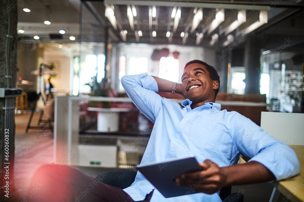 Young African American man using the tablet in a company office Young African American man using the tablet in a company office