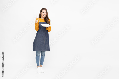 Restaurant owner small business Asian woman with apron holding empty white plate or dish isolated on white background, SME Concept © comzeal