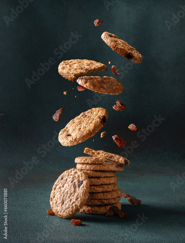 Konstfotografi Delicious oatmeal cookies with raisin falling into a stack