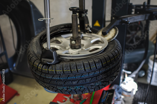 Tyre removed from the rim by tyre changer for cars and motorcycles in the workshop.