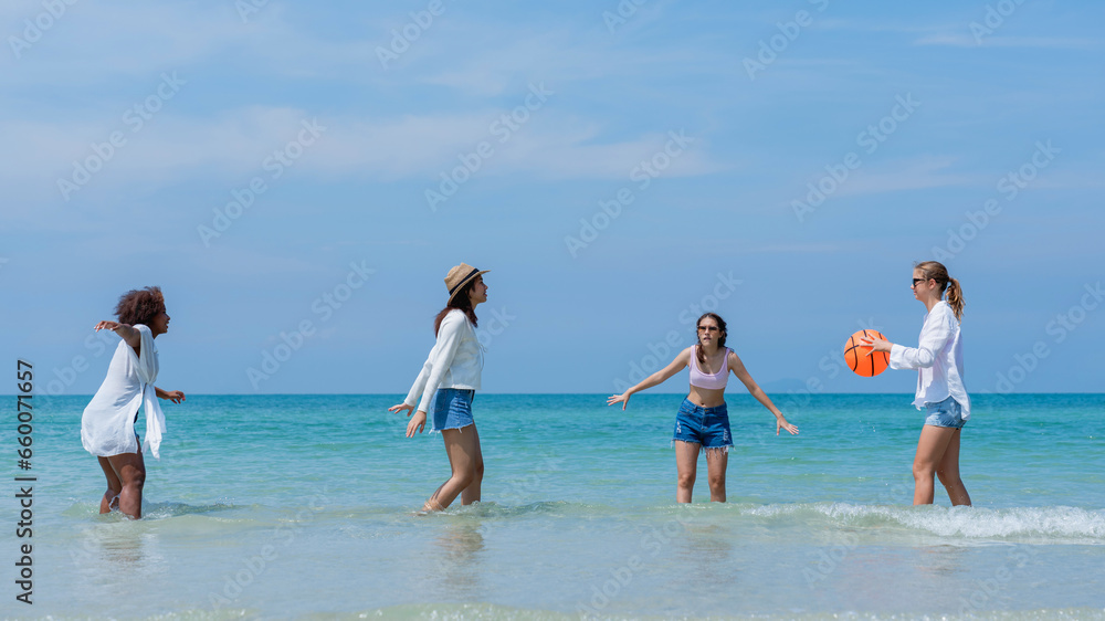 Happy children laughing and enjoying at beach. Teenage playing with friends at the sea. Vacations time and friendship concept.
