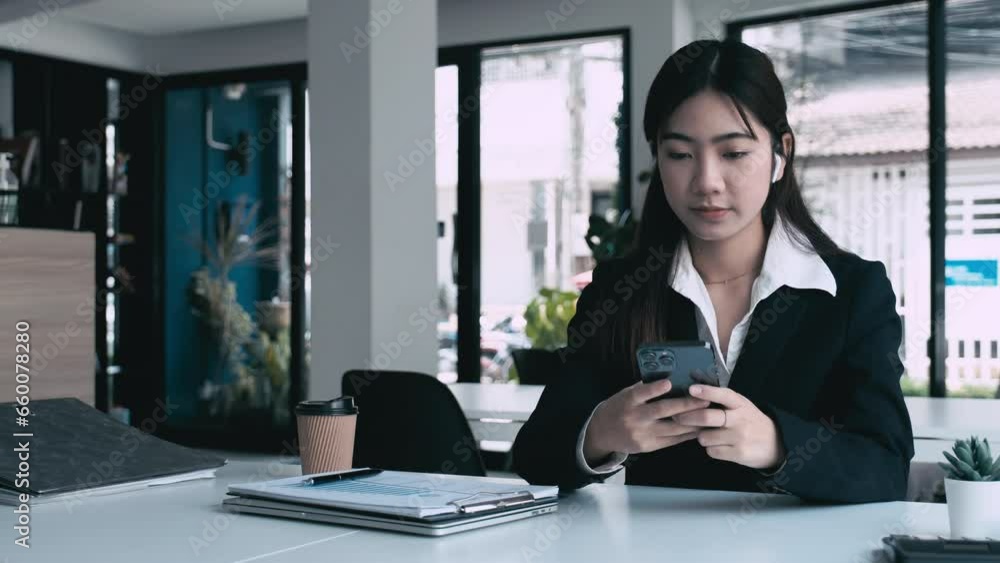 Young, beautiful woman in casual clothes sits at a desk in her dedicated workspace delves into online study or diligently works on her project with her laptop, notebook, and headphones. Young, beautiful woman in casual clothes sits at a desk in her dedicated workspace delves into online study or diligently works on her project with her laptop, notebook, and headphones.
