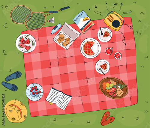 Summer picnic on green grass top view. Basket with bread and bottle of wine, pie in plates, radio