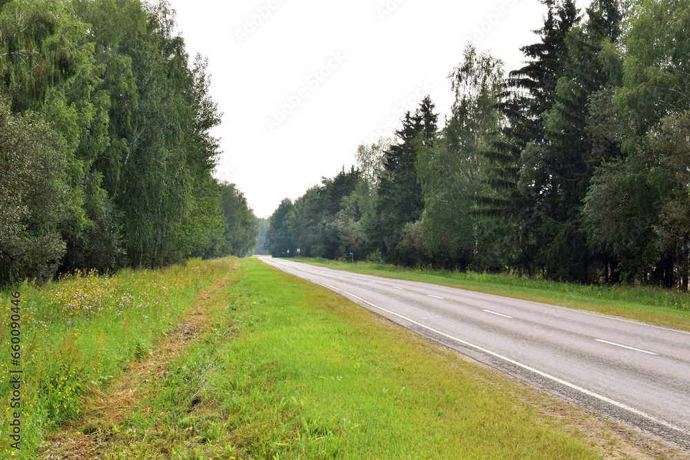 Automobile highway, which goes to the distance in the north of Russia