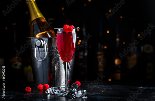 Tableau sur toile Moulin rouge cocktail drink with calvados, sparkling wine, lychee and raspberry