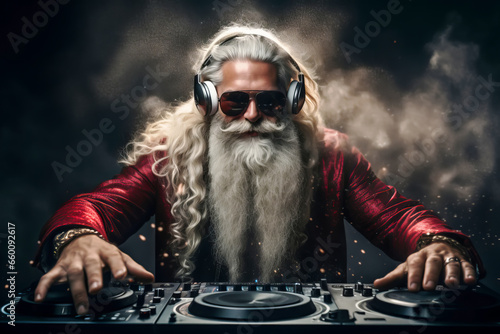 Santa Claus DJ working spinning turntable records at Christmas party photo