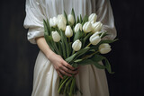 Woman Holding a Bouquet of White Tulips