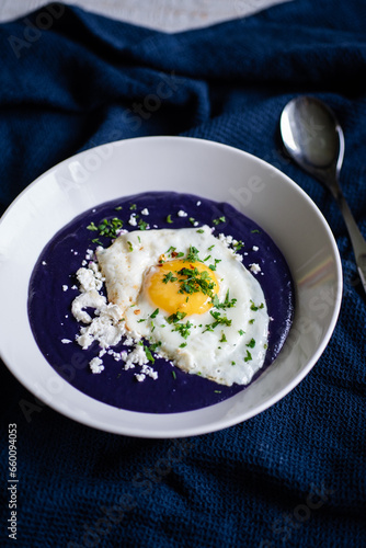 Purple potato soup with feta cheese and seeds