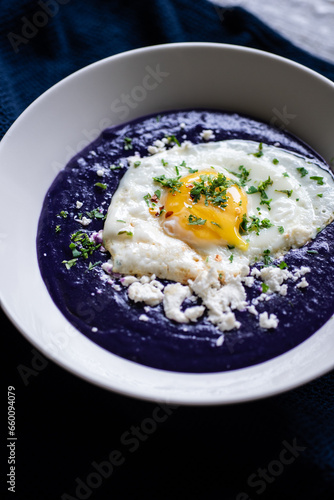 Purple potato soup with feta cheese and seeds