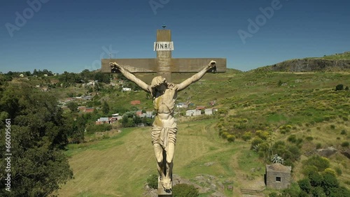 360 degre drone shot around a Christ statue on top of the mountain in the center of Tandil in Argentina photo