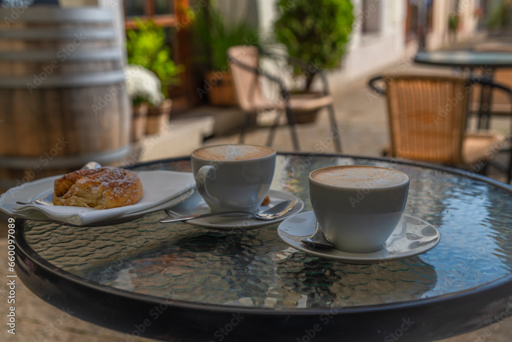 Fototapeta premium Small breakfast with coffee near old square in sunny hot autumn day in Kadan