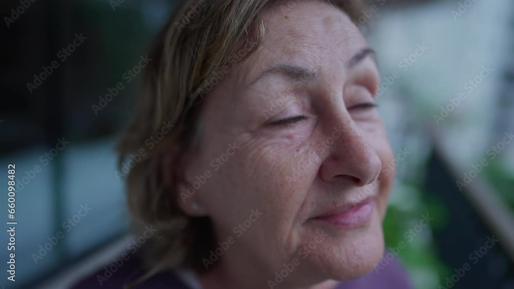 Close-up face of a senior woman staring at sky in contemplation. Pensive older lady in 70s with thoughtful expression Close-up face of a senior woman staring at sky in contemplation. Pensive older lady in 70s with thoughtful expression