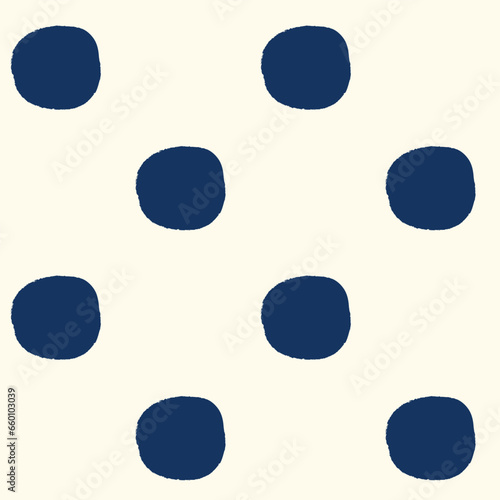 All over seamless repeat pattern with dark navy blue polka dots with grunge edges half drop on cream. Versatile trendy modern background
