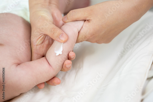신생아의 몸에 크림을 바르는 엄마의 손 photo