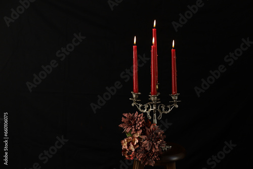 Red candles on the antique chandelier with black background
