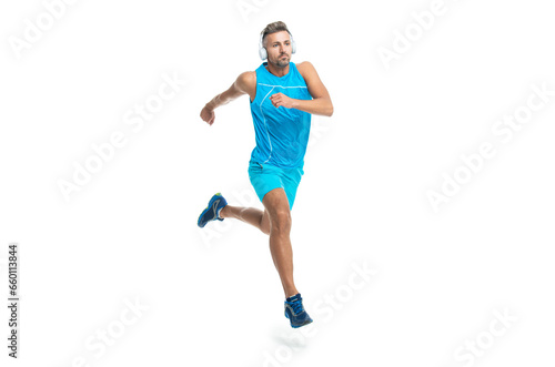 sport jogger listening to music in headphones. The jogger ran at sport training isolated on white. In a morning sport workout jogger run in studio. The jogger stretched legs before running © be free