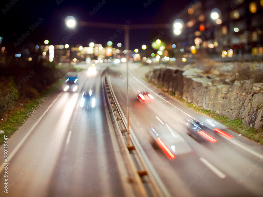 Long exposure tilt shift image of traffic passing on a highway. Long exposure tilt shift image of traffic passing on a highway.