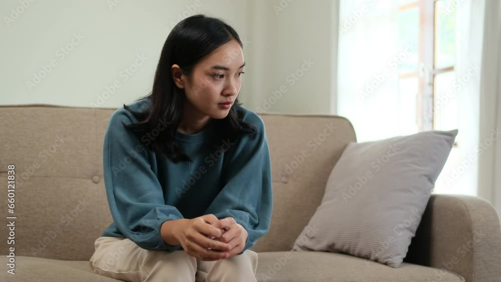 Asian woman having work call, talking with colleagues.